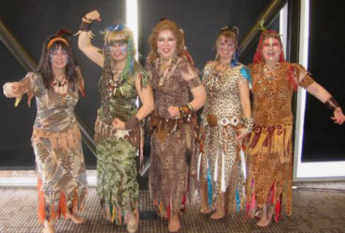 Five dancers in animal print costumes