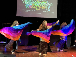 Three dancers with colorful veils